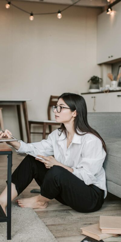 Woman Sitting On The Floor While Using Her Laptop