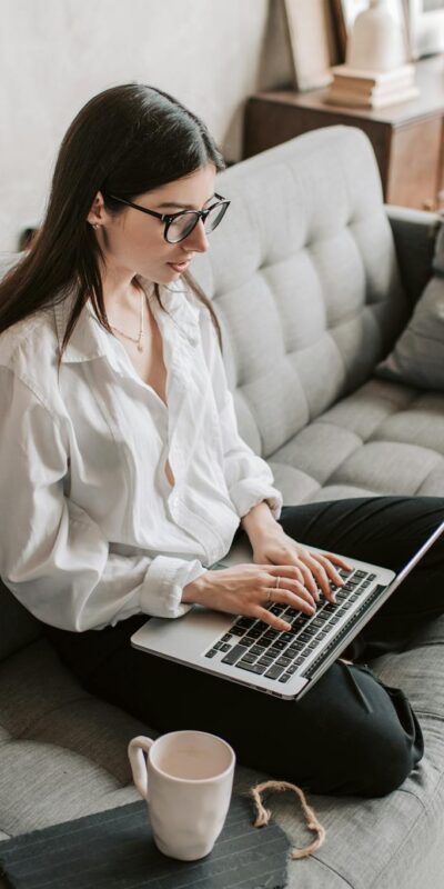 Woman Working At Home Using Laptop